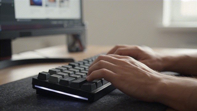 A developer typing on a laptop while working on software.